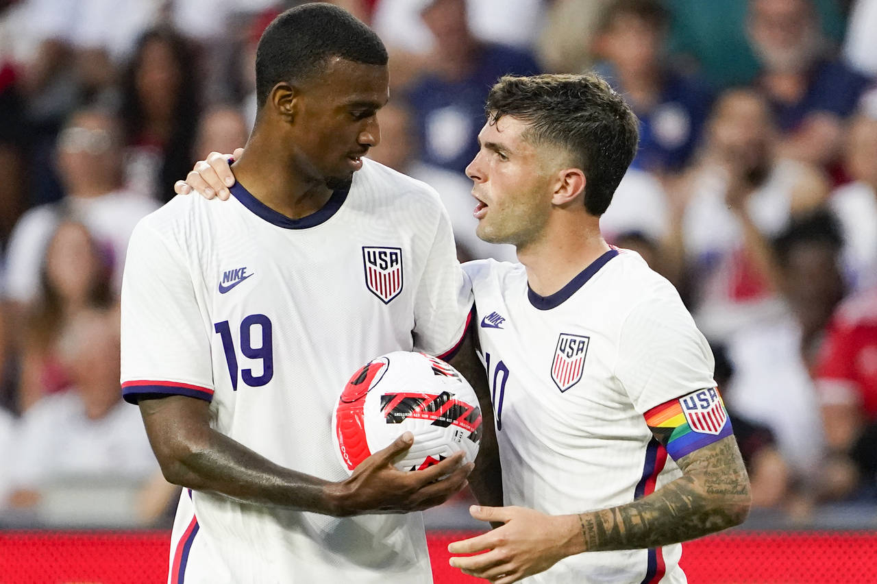 U.S. forward Christian Pulisic, right, hands the ball to Haji Wright (19) prior to a penalty kick d...