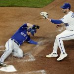 
              Toronto Blue Jays' Bradley Zimmer slides home to score on a wild pitch by Kansas City Royals relief pitcher Dylan Coleman, right, during the seventh inning of a baseball game Tuesday, June 7, 2022, in Kansas City, Mo. (AP Photo/Charlie Riedel)
            