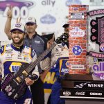 
              Chase Elliott poses with his guitar and trophy after winning a NASCAR Cup Series auto race Sunday, June 26, 2022, in Lebanon, Tenn. (AP Photo/Mark Humphrey)
            