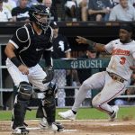 
              Baltimore Orioles shortstop Jorge Mateo, right, scores on a single by Richie Martin as Chicago White Sox catcher Reese McGuire waits for the throw during the second inning of a baseball game in Chicago, Friday, June 24, 2022. (AP Photo/Nam Y. Huh)
            