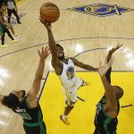 
              Golden State Warriors forward Andrew Wiggins, middle, shoots against Boston Celtics guard Derrick White, left, and center Al Horford during the first half of Game 5 of basketball's NBA Finals in San Francisco, Monday, June 13, 2022. (AP Photo/Jed Jacobsohn, Pool)
            