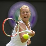 
              Estonia's Anett Kontaveit returns the ball to Germany's Jule Niemeier during their singles tennis match on day three of the Wimbledon tennis championships in London, Wednesday, June 29, 2022. (AP Photo/Kirsty Wigglesworth)
            