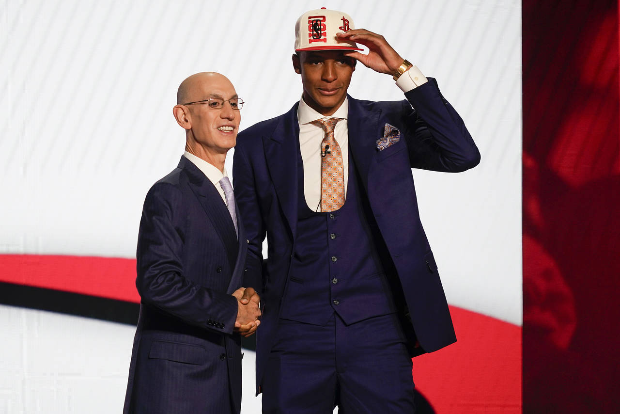 Jabari Smith Jr., right, is congratulated by NBA Commissioner Adam Silver after being selected thir...