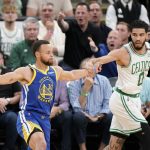 
              Golden State Warriors guard Stephen Curry (30) looks to pass against Boston Celtics forward Jayson Tatum (0) during the first quarter of Game 6 of basketball's NBA Finals, Thursday, June 16, 2022, in Boston. (AP Photo/Steven Senne)
            