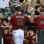
              Arizona Diamondbacks' Daulton Varsho (12) celebrates after scoring a run against the Detroit Tigers with teammate David Peralta, left, and manager Torey Lovullo, right, during the fourth inning of a baseball game Sunday, June 26, 2022, in Phoenix. (AP Photo/Ross D. Franklin)
            