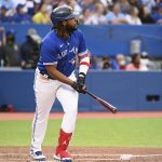 
              Toronto Blue Jays' Vladimir Guerrero Jr watchers his two-run home run, which also scored Bo Bichette, clear the wall in the third inning of a baseball game against the Boston Red Sox in Toronto, Monday, June 27, 2022. (Jon Blacker/The Canadian Press via AP)
            