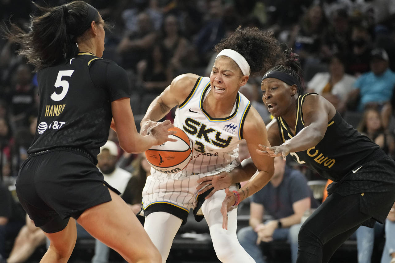 Chicago Sky forward Candace Parker, center, battles for the ball with Las Vegas Aces forward Dearic...