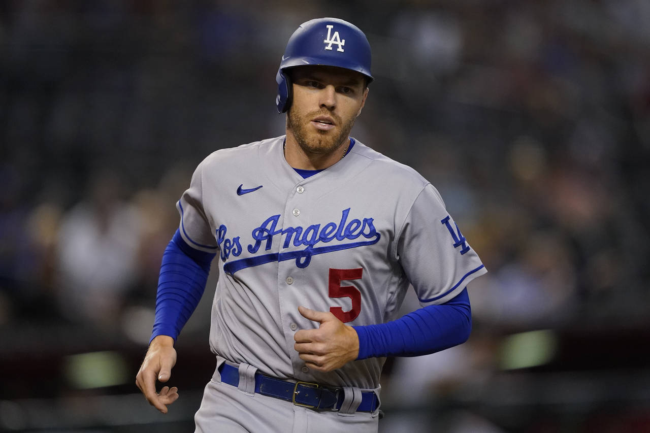 Los Angeles Dodgers' Freddie Freeman (5) scores on a triple hit by Trea Turner during the sixth inn...