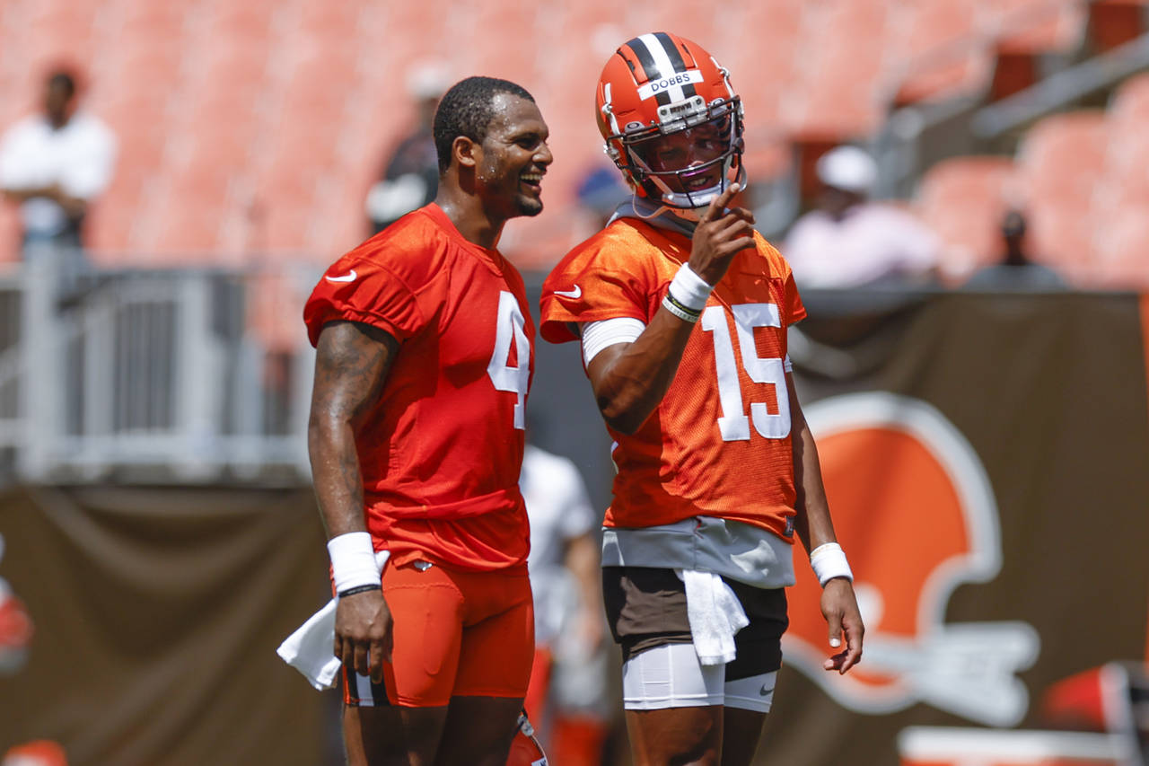 Cleveland Browns quarterback Deshaun Watson (4) talks with Joshua Dobbs (15) during an NFL football...