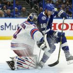 
              Tampa Bay Lightning center Riley Nash (16) crashes into New York Rangers goaltender Igor Shesterkin (31) during the second period in Game 3 of the NHL hockey Stanley Cup playoffs Eastern Conference finals Sunday, June 5, 2022, in Tampa, Fla. Nash was called for a penalty on the play. (AP Photo/Chris O'Meara)
            