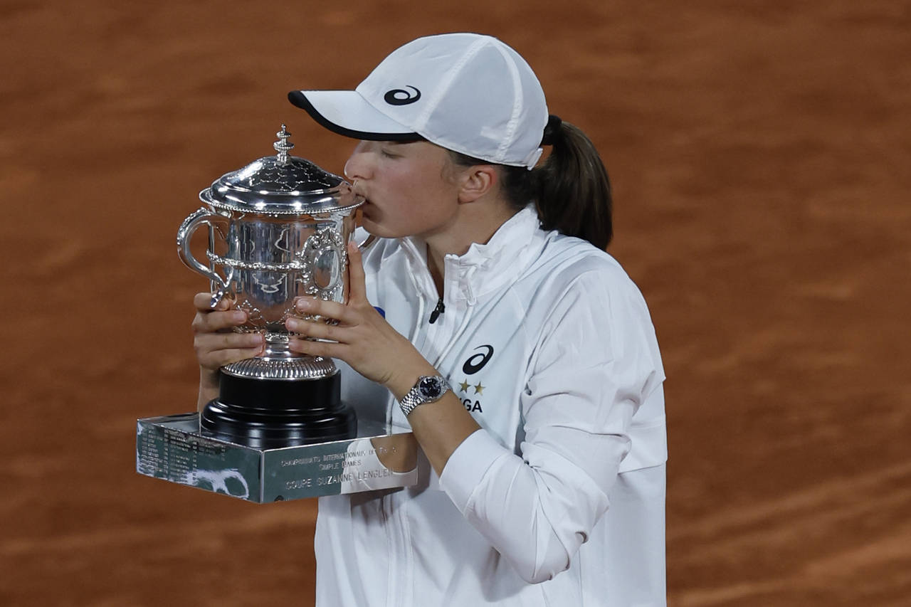 Poland's Iga Swiatek kisses the cup after defeating Coco Gauff of the U.S.in their final of the Fre...