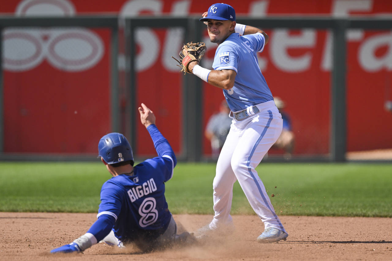 Kansas City Royals second baseman Nicky Lopez gets the force out on Toronto Blue Jays' Cavan Biggio...