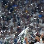 
              Real Madrid's Karim Benzema holds the trophy after the Champions League final soccer match between Liverpool and Real Madrid at the Stade de France in Saint Denis near Paris, Saturday, May 28, 2022. Real won 1-0. (AP Photo/Petr David Josek)
            