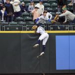 
              Seattle Mariners center fielder Taylor Trammell leaps but cannot catch a home run by Minnesota Twins' Byron Buxton during the first inning of a baseball game, Monday, June 13, 2022, in Seattle. (AP Photo/John Froschauer)
            