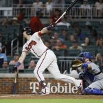 
              Atlanta Braves' Austin Riley hits an RBI single, scoring Michael Harris II during the seventh inning of a baseball game won by the Los Angeles Dodgers 5-3 on Sunday, June 26, 2022, in Atlanta. (AP Photo/Bob Andres)
            