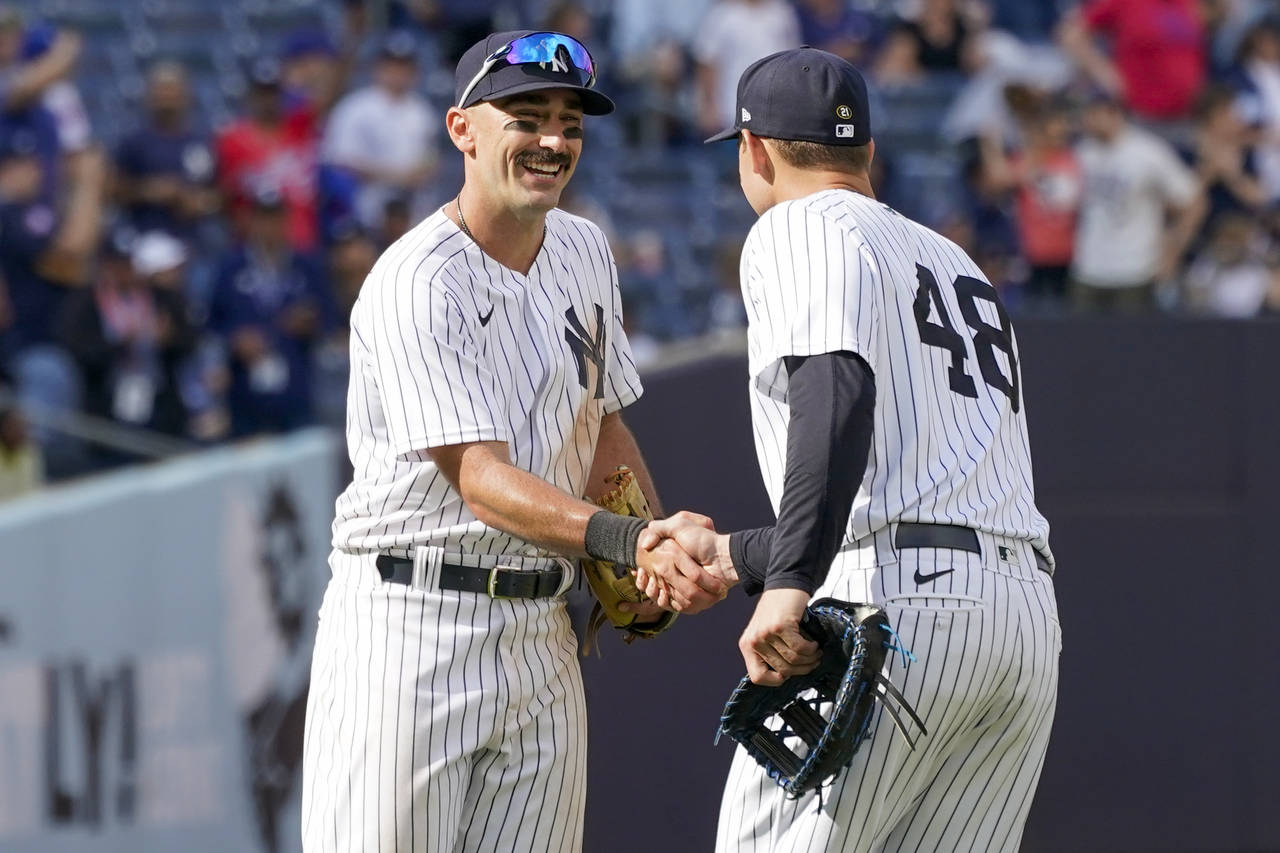 New York Yankees' Matt Carpenter, left, celebrates with Anthony Rizzo (48) after they defeated the ...