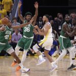 
              Golden State Warriors' Stephen Curry passes the ball past Boston Celtics' Al Horford (42) and Marcus Smart during the fourth quarter of Game 1 of basketball's NBA Finals, Thursday, June 2, 2022, in San Francisco. (Strazzante/San Francisco Chronicle via AP)
            