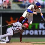 
              Philadelphia Phillies' Bryson Stott, top, leaps after a force-out to avoid the slide by Los Angeles Angels' Jo Adell, bottom, during the fourth inning of a baseball game, Sunday, June 5, 2022, in Philadelphia. (AP Photo/Derik Hamilton)
            
