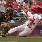 
              St. Louis Cardinals' Nolan Arenado (28) scores past San Diego Padres catcher Austin Nola during the eighth inning of a baseball game Wednesday, June 1, 2022, in St. Louis. (AP Photo/Jeff Roberson)
            