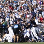 
              Mississippi's Jack Washburn, right, leaps on top of the team pile in celebration of their 4-2 victory over Oklahoma in Game 2 of the NCAA College World Series baseball finals, Sunday, June 26, 2022, in Omaha, Neb. Mississippi defeated Oklahoma 4-2 to win the championship. (AP Photo/Rebecca S. Gratz)
            