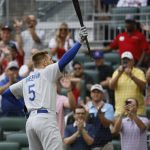 
              Los Angeles Dodgers' Freddie Freeman reacts to a standing ovation as he takes his first at-bat during the first inning of a baseball game against the Atlanta Braves, Sunday, June 26, 2022, in Atlanta. (AP Photo/Bob Andres)
            