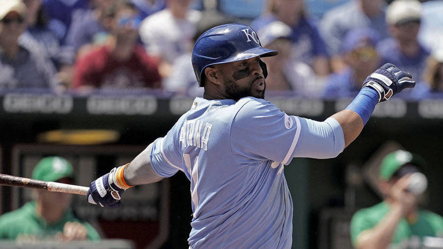 Carlos Santana hits a two-run single for the Royals against the A's on Sunday. (AP Photo/Charlie Ri...