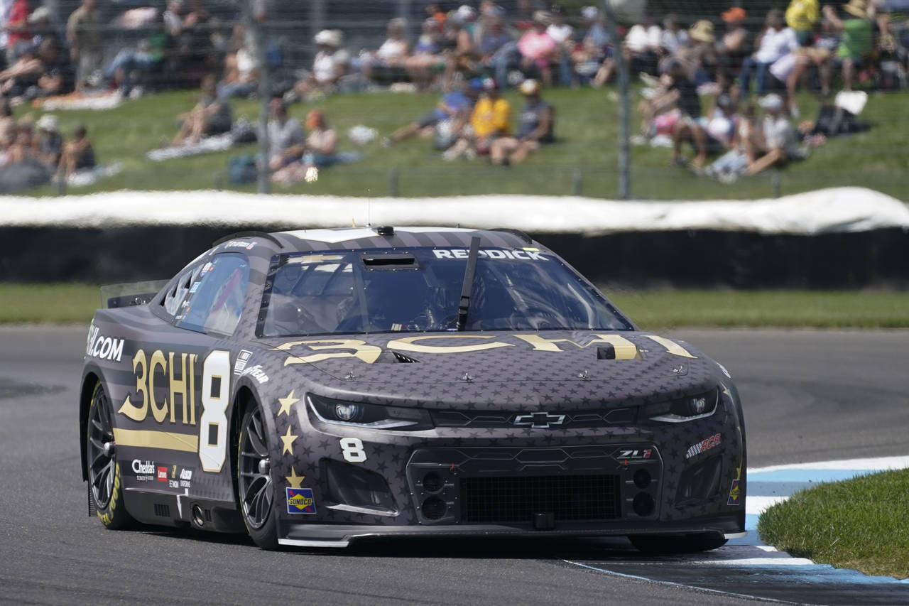 Tyler Reddick drives into a turn during a NASCAR Cup Series auto race at Indianapolis Motor Speedwa...