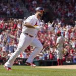 
              St. Louis Cardinals' Albert Pujols, left, rounds the bases after hitting a solo home run off Philadelphia Phillies relief pitcher Cristopher Sanchez, right, during the sixth inning of a baseball game Sunday, July 10, 2022, in St. Louis. (AP Photo/Jeff Roberson)
            