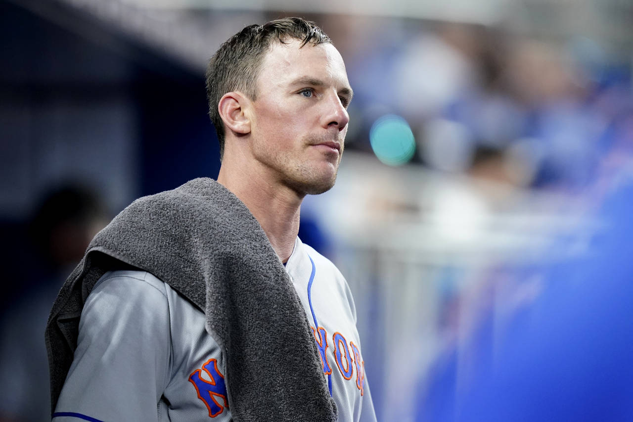 New York Mets starting pitcher Chris Bassitt looks out from the dugout after pitching in the fourth...