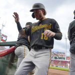 
              Pittsburgh Pirates' Ben Gamel (18) returns to the dugout after scoring on a single by Daniel Vogelbach during the third inning against the Cincinnati Reds in the second baseball game of a doubleheader Thursday, July 7, 2022, in Cincinnati. (AP Photo/Jeff Dean)
            