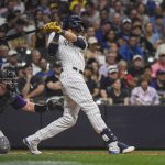 
              Milwaukee Brewers' Christian Yelich follows through on an RBI single during the sixth inning of the team's baseball game against the Colorado Rockies on Saturday, July 23, 2022, in Milwaukee. (AP Photo/Kenny Yoo)
            