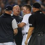 
              Detroit Tigers' Spencer Torkelson, third from left, is checked on by manager A.J. Hinch, left, and athletic trainer Doug Teter after being hit in the head by a pitch in the seventh inning of a baseball game against the Kansas City Royals in Detroit, Friday, July 1, 2022. Torkelson left the game. (AP Photo/Paul Sancya)
            