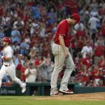 
              St. Louis Cardinals' Corey Dickerson, left, rounds the bases after hitting a two-run home run off Philadelphia Phillies starting pitcher Aaron Nola, right, during the seventh inning of a baseball game Monday, July 11, 2022, in St. Louis. (AP Photo/Jeff Roberson)
            