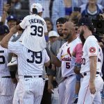 
              National League's Albert Pujols, of the St. Louis Cardinals, (5) is greeted by fellow players during the MLB All-Star baseball Home Run Derby, Monday, July 18, 2022, in Los Angeles. (AP Photo/Jae C. Hong)
            