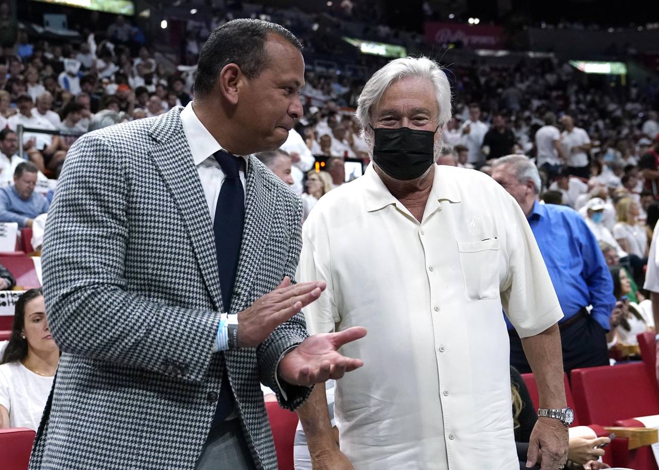 FILE - Former MLB player Alex Rodriguez applauds with Micky Arison, owner of the Miami Heat, before...