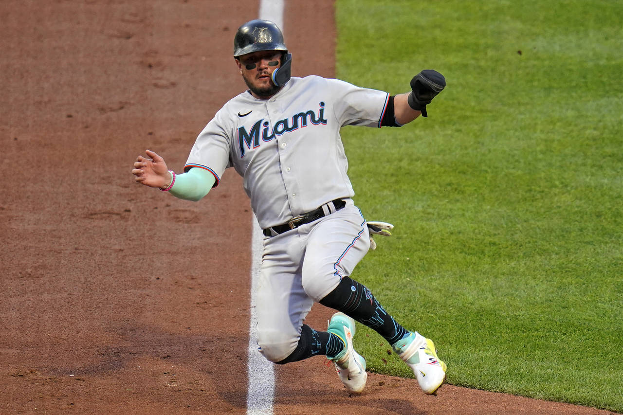 Miami Marlins' Miguel Rojas scores from third on a groundout by Nick Fortes during the fourth innin...