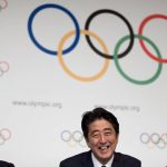 
              FILE - Then Japan's Prime Minister Shinzo Abe, center, smiles next to the President of the International Olympic Committee Jacques Rogge, left, as Tokyo 2020 Olympic Bid Committee President Tsunekazu Takeda, right, looks on after signing the Host City Contract for the 2020 Olympic Games in Buenos Aires, Argentina, Saturday, Sept. 7, 2013. Former Prime Minister Shinzo Abe was the country’s central figure in landing the 2020 Olympics for Tokyo. Abe died after being shot while campaigning in western Japan on July 8, 2022. (AP Photo/Natacha Pisarenko, File)
            
