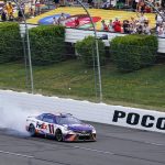 
              ADDS THAT HAMLIN WAS LATER DISQUALIFIED - Denny Hamlin (11) does a burnout as he celebrates after winning a NASCAR Cup Series auto race at Pocono Raceway, Sunday, July 24, 2022, in Long Pond, Pa. NASCAR stripped Hamlin of his win when his No. 11 Toyota failed inspection and was disqualified, awarding Chase Elliott the Cup Series victory. (AP Photo/Matt Slocum)
            