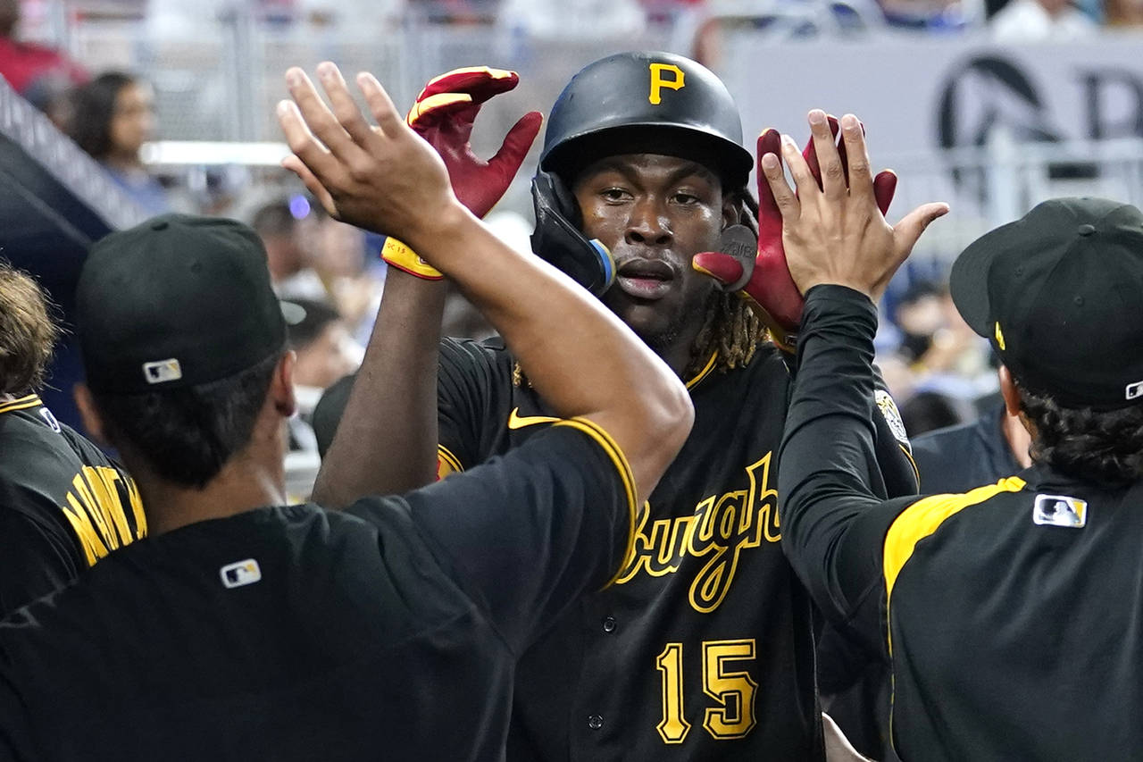 Pittsburgh Pirates' Oneil Cruz (15) is congratulated after scoring on a single hit by Jason Delay d...