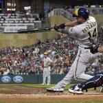 
              Milwaukee Brewers Jace Peterson (14) hits an RBI single against the Minnesota Twins in the sixth inning of a baseball game, Tuesday, July 12, 2022, in Minneapolis. The Brewers won 6-3. (AP Photo/Jim Mone)
            