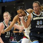 
              Chicago Sky's Julie Allemand (20) blocks out Las Vegas Aces' Kiah Stokes for a loose ball as teammate Emma Meesseman also defends during the first half of the WNBA Commissioner's Cup basketball game Tuesday, July 26, 2022, in Chicago. (AP Photo/Charles Rex Arbogast)
            