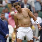 
              FILE - Spain's Rafael Nadal sports tape on his stomach following a medical timeout as he plays Taylor Fritz of the US in a men's singles quarterfinal match on day ten of the Wimbledon tennis championships in London, Wednesday, July 6, 2022. Rafael Nadal has announced he has withdrawn from Wimbledon due to injury, handing Nick Kyrgios a walkover into Sunday's men's singles final. (AP Photo/Kirsty Wigglesworth, File)
            