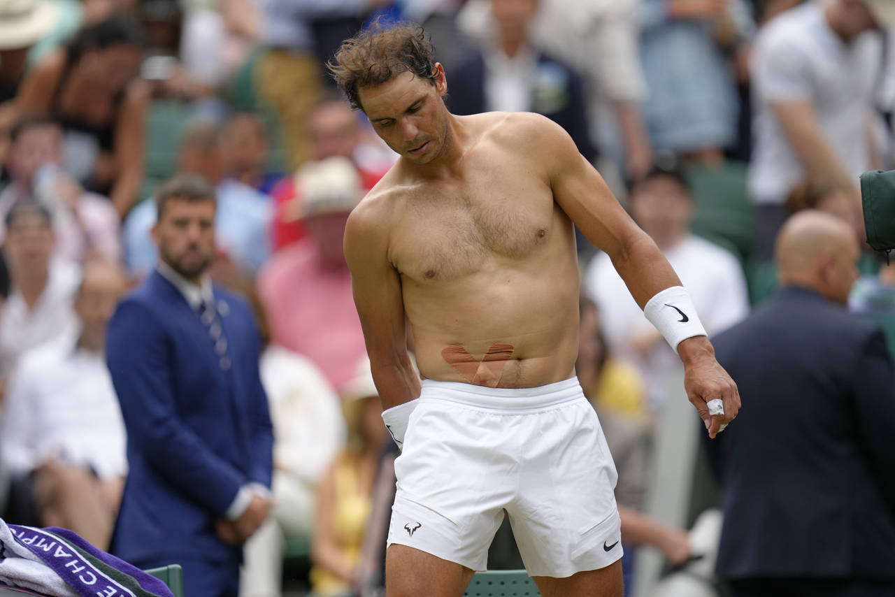 FILE - Spain's Rafael Nadal sports tape on his stomach following a medical timeout as he plays Tayl...