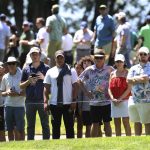 
              People watch golfers on the third green during the first round of the Portland Invitational LIV Golf tournament in North Plains, Ore., Thursday, June 30, 2022. (AP Photo/Steve Dipaola)
            