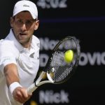 
              Serbia's Novak Djokovic returns to Australia's Nick Kyrgios during the final of the men's singles on day fourteen of the Wimbledon tennis championships in London, Sunday, July 10, 2022. (AP Photo/Kirsty Wigglesworth)
            