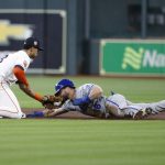 
              Kansas City Royals' Andrew Benintendi steals second base next to Houston Astros shortstop Jeremy Pena during the first inning of a baseball game Wednesday, July 6, 2022, in Houston. (AP Photo/Kevin M. Cox)
            