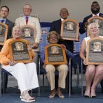 
              Clockwise from top left, Josh Rawitch, president of the National Baseball Hall of Fame and Museum, holding the plaque of inductee Bud Fowler, inductee Jim Kaat, inductee Tony Oliva, inductee David Ortiz, Sharon Rice-Minoso, holding the plaque of her husband and inductee Minnie Minoso, Dr. Angela Terry, holding the plaque of her uncle and inductee John Jordan O'Neil, and Irene Hodges, holding the plaque of her father and inductee Gil Hodges, pose for a photo at the conclusion of the National Baseball Hall of Fame induction ceremony, Sunday, July 24, 2022, at the Clark Sports Center in Cooperstown, N.Y. (AP Photo/John Minchillo)
            