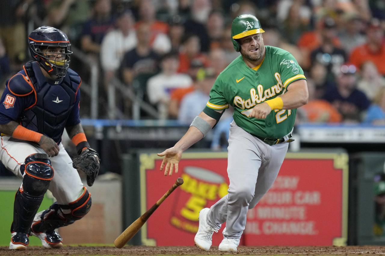 Oakland Athletics' Stephen Vogt hits a RBI single during the eighth inning of a baseball game again...