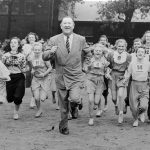 
              FILE - Big Jim Thorpe, famed American athlete and former U.S. Olympic great, center, sets a fast pace for some girls during a "junior olympics" event on Chicago's south side June 6, 1948 sponsored by a V.F.W. post. Jim Thorpe has been reinstated as the sole winner of the 1912 Olympic pentathlon and decathlon — nearly 110 years after being stripped of those gold medals for violations of strict amateurism rules of the time. The International Olympic Committee confirmed that an announcement was planned later Friday, July 15, 2022. (AP Photo, File)
            