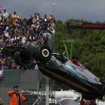 
              Damaged car of Mercedes driver George Russell of Britain is lifted during the British Formula One Grand Prix at the Silverstone circuit, in Silverstone, England, Sunday, July 3, 2022. (AP Photo/Matt Dunham, Pool)
            